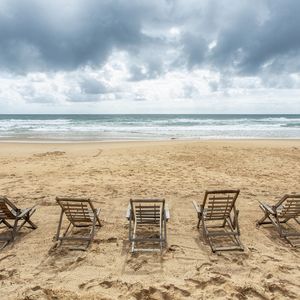 DIA NUBLADO E CADEIRAS VAZIAS NA PRAIA - QUADRADA