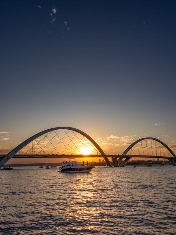 PONTE JK COM PÔR DO SOL E LANCHA EM DESTAQUE
