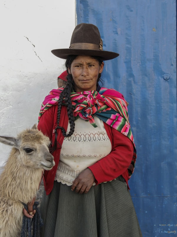 MULHER EM TRAJE TÍPICO COM UMA LHAMA EM CUSCO PERU