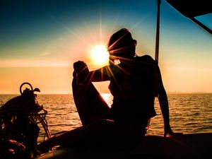 WOMAN ON THE BOAT SUNSET