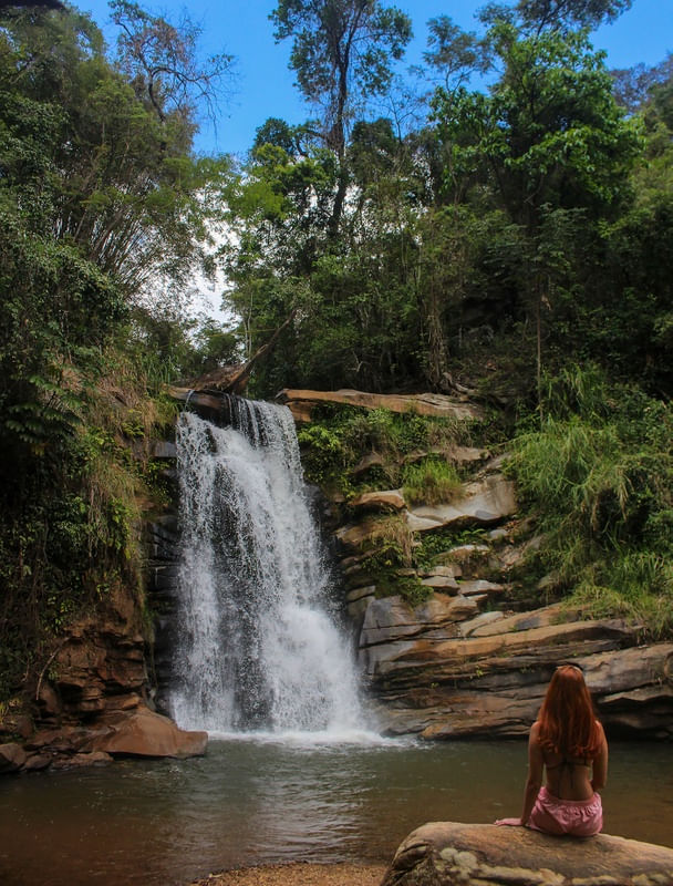 MULHER OBSERVANDO A CACHOEIRA NO INTERIOR DE MINAS GERAIS